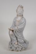 A Chinese blanc de chine porcelain Quan Yin with crackle glaze decorated to the robe, impressed