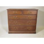 An oak chest, two + three drawers, with moulded fronts and brass swan neck handles, raised on a