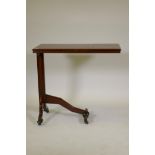 A C19th plum pudding mahogany campaign style reading stand, with height adjustable top and ratcheted