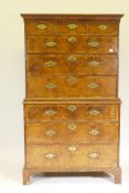 A Georgian walnut chest on chest, with featherbanded inlay and moulded rail decoration, the upper