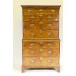 A Georgian walnut chest on chest, with featherbanded inlay and moulded rail decoration, the upper