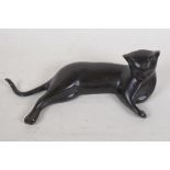 A bronze figure of a reclining Siamese cat, 12" wide