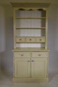 A painted pine dresser, the upper section with closed rack and three drawers, the lower with two