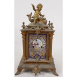 A French C19th gilt mantel clock with cast case surmounted by a cherub and dolphin, with Sevres