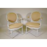 A pair of open arm tub shaped chairs, with spoon backs, raised on turned supports, later painted,