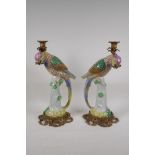 A pair of polychrome porcelain parrot candlesticks with bronze mounts, 16" high