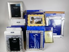 Thirty two silver plated photo frames, various sizes and designs, all new and boxed