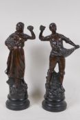 A pair of bronzed spelter figures of flower pickers on turned wood socles, 13" high