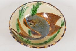 A Middle Eastern studio pottery red earthenware bowl with high fired drip glaze, the interior