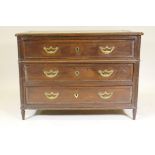 An C18th French oak commode, the three drawers with moulded edges and original brass handles,