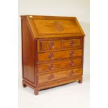 A Chinese hardwood fall front bureau, the fall carved with an auspicious symbol over two short and