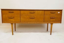 A mid century teak six drawer side cabinet, 61" x 17" x 27"