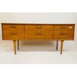 A mid century teak six drawer side cabinet, 61" x 17" x 27"