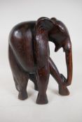 A carved hardwood figure of a stylised elephant, 13" high