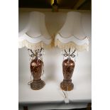 A pair of coppered glass table lamps on pierced gilt bases with applied gilt metal decoration and
