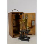 A Dollond monocular microscope inscribed E. Leitz, London, Wetzlar No 120332, in fitted case, 7" x