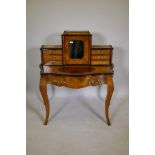 A Victorian inlaid figured walnut ormolu mounted bonheur de jour, with ebonised decoration, the