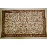 An old Turkish Hereke hand woven green ground woven wool rug with an allover floral design, 55" x