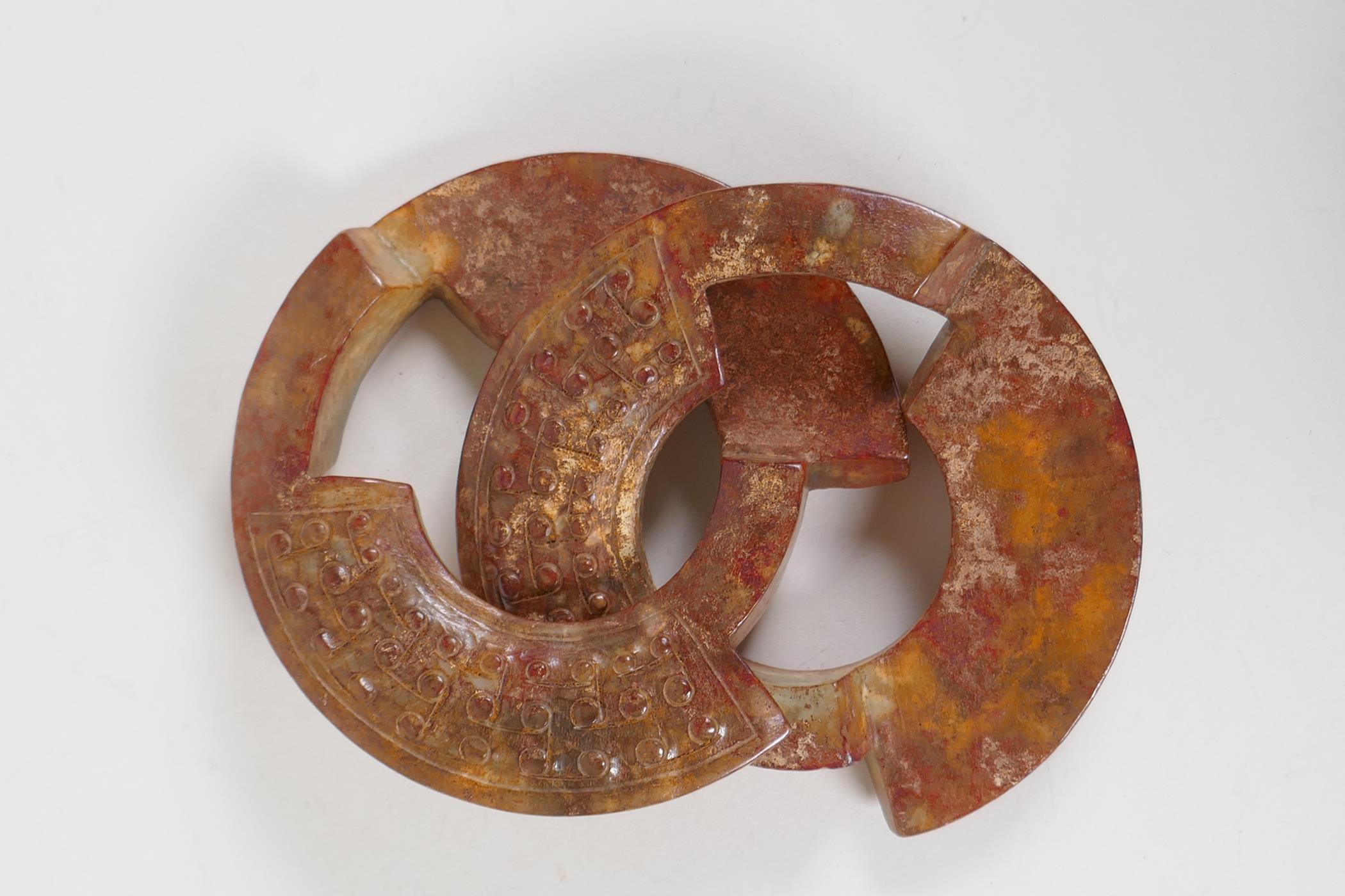 A Chinese archaic carved hardstone puzzle ring, 4½" diameter - Image 2 of 2