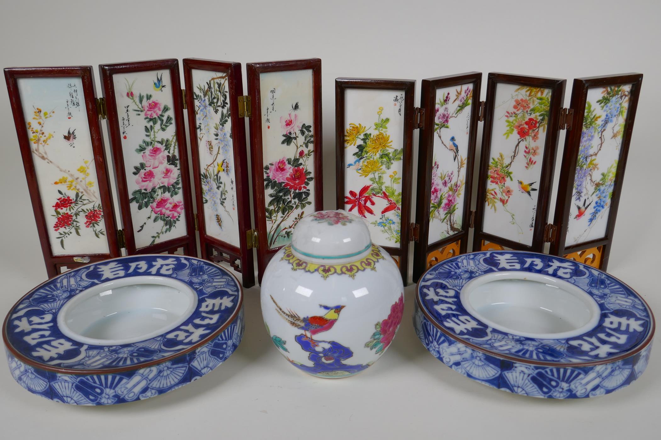 A pair of Japanese blue and white porcelain shallow bowls decorated with fans and characters, 7" - Image 2 of 2