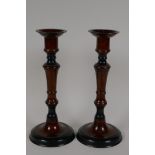 A pair of bronze candlesticks with wood effect patinated finish, 10" high