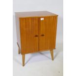 A mid century 'Arnold' sapele wood record cabinet, the interior fitted with drop down record holders