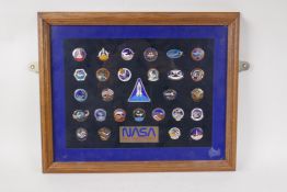 A collection of 28 NASA official astronaut crew insignia enamel badges from the Space Shuttle