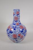 A blue and white porcelain bottle vase decorated with red chrysanthemums and pomegranates, Chinese