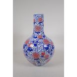 A blue and white porcelain bottle vase decorated with red chrysanthemums and pomegranates, Chinese