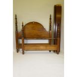 A mahogany bed frame, with arched head board and turned posts, 60" wide, 66" high