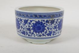 A blue and white porcelain steep sided bowl/censer on tripod supports with scrolling floral