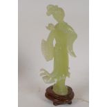 A carved greenstone figure of a Chinese lady, on a hardwood base, 8" high