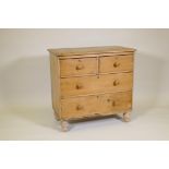 A Victorian stripped pine chest of two over two drawers, raised on turned supports, 34" x 19" x 33"