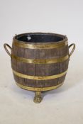 An antique coopered barrel jardiniere with brass banding, 16" high x 15" diameter