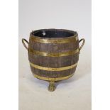 An antique coopered barrel jardiniere with brass banding, 16" high x 15" diameter