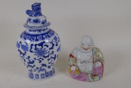 A Chinese porcelain figure of a laughing Buddha painted in bright enamels, 5½" high, and a Chinese