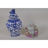 A Chinese porcelain figure of a laughing Buddha painted in bright enamels, 5½" high, and a Chinese