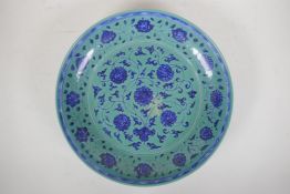 A Ming style turquoise ground porcelain charger with scrolling lotus flower decoration, Chinese