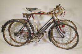 A vintage continental road racing bike and a vintage lady's bicycle with sprung seat, 25½" wheels