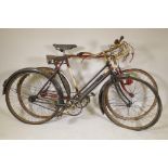 A vintage continental road racing bike and a vintage lady's bicycle with sprung seat, 25½" wheels