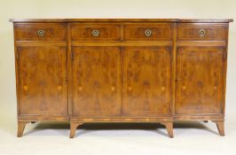 G.T. Rackstraw, a good yew wood breakfront side board, with four drawers over four cupboards, raised