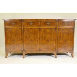 G.T. Rackstraw, a good yew wood breakfront side board, with four drawers over four cupboards, raised