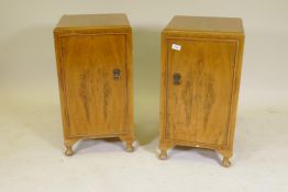 A pair of 1930s walnut bedside cupboards, raised on cabriole supports, 15" x 15" x 27"