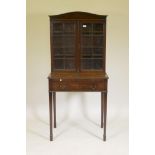 A C19th mahogany writing table, the upper section with two glazed doors, the lower with reeded