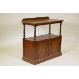 A Victorian mahogany two tier buffet, the top with shaped back raised on tapering turned supports