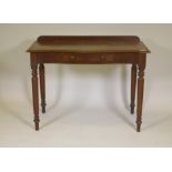A Victorian mahogany single drawer writing table, with serpentine shaped top, raised on turned