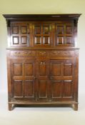 An antique C18th Welsh oak duaddern, the upper section with Greek key carved cornice over the