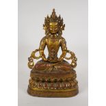 A Sino Tibetan gilt bronze figure of Buddha seated on a lotus throne, 14½" high