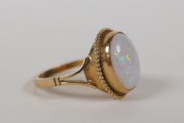 A 9ct yellow gold and opal set ring, size L/M