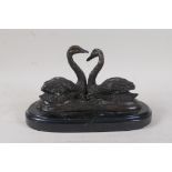 A bronze figure of two swans, 9" wide